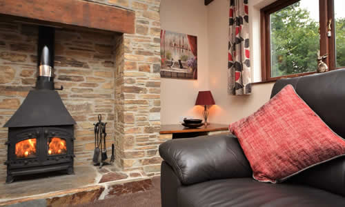 Cosy woodburner stove in Bramble Cottage